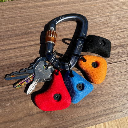 Keychain with colorful heart-shaped key holders and keys on a wooden surface