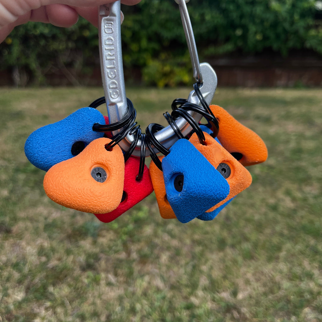 Colorful keychain with rock climbing holds on a blurred green background